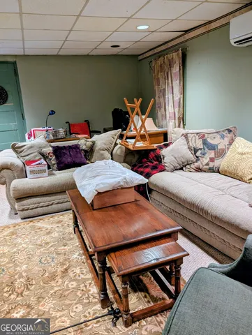 a living room with furniture and a rug