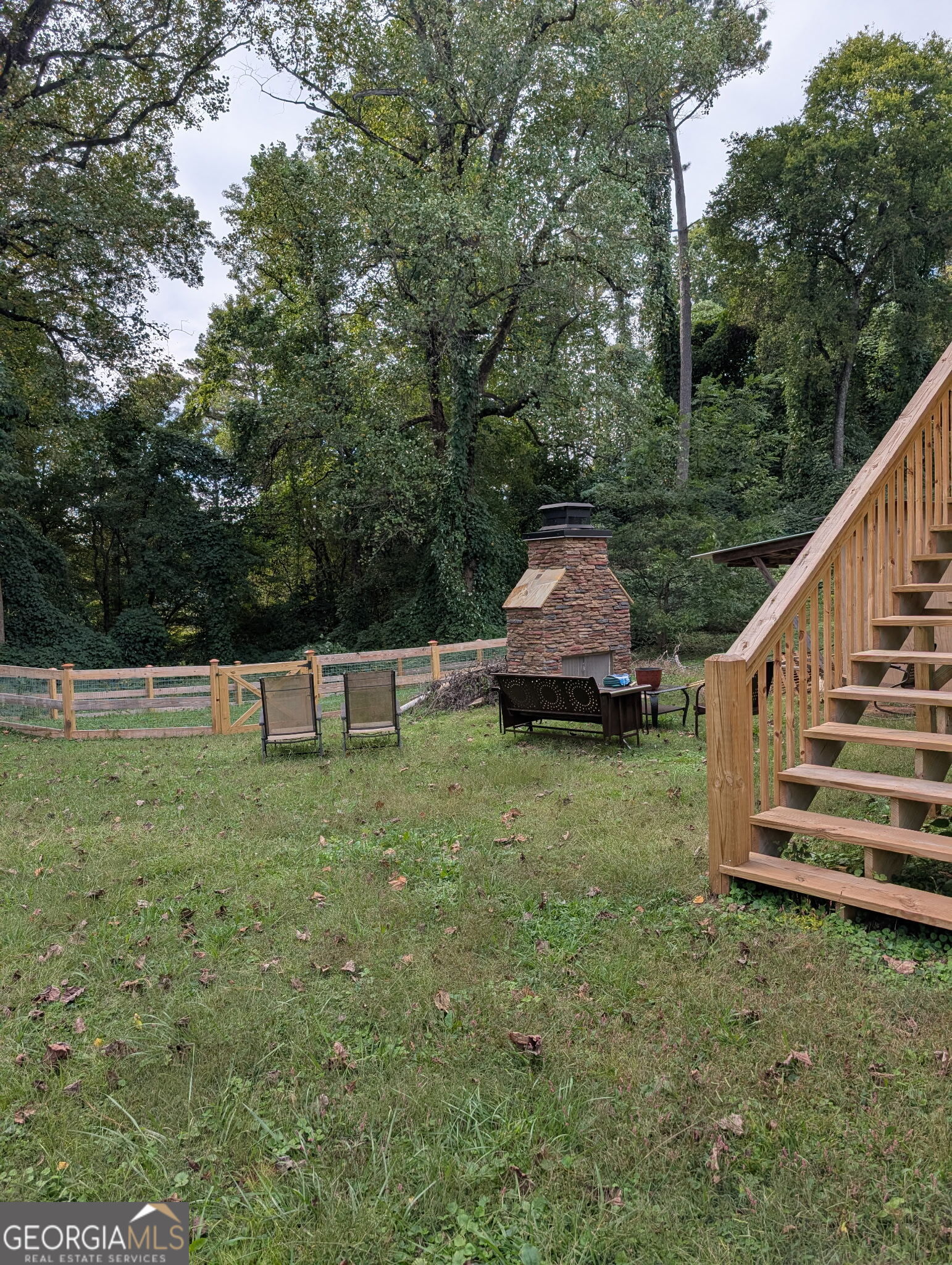 6771 Highway 53 Tate, GA 30177 - Photo 7 of 7 a view of a backyard with wooden fence and large trees