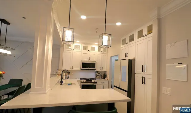 a kitchen with stainless steel appliances a refrigerator sink and stove