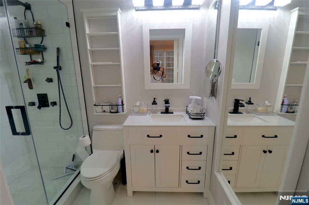 163 Conover Terrace Lebanon, NJ 08833 - Photo 4 of 23 a bathroom with a double vanity sink toilet mirror and shower