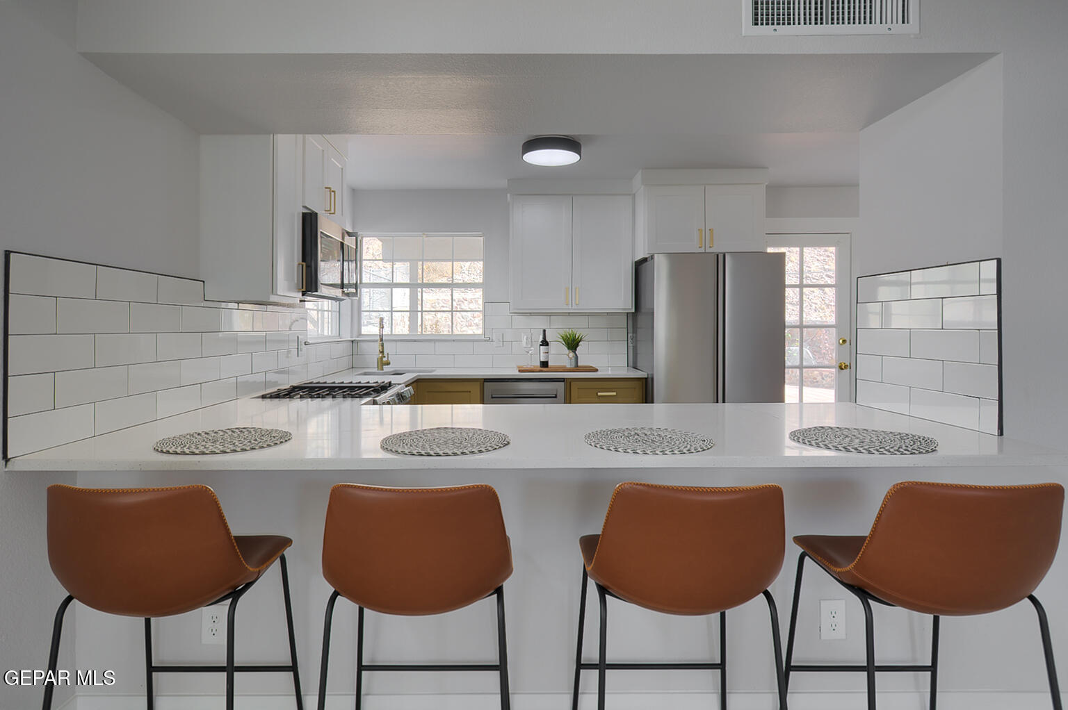 7413 Le Conte Drive El Paso, TX 79912 - Photo 12 of 50 a kitchen with stainless steel appliances granite countertop a table chairs and a refrigerator