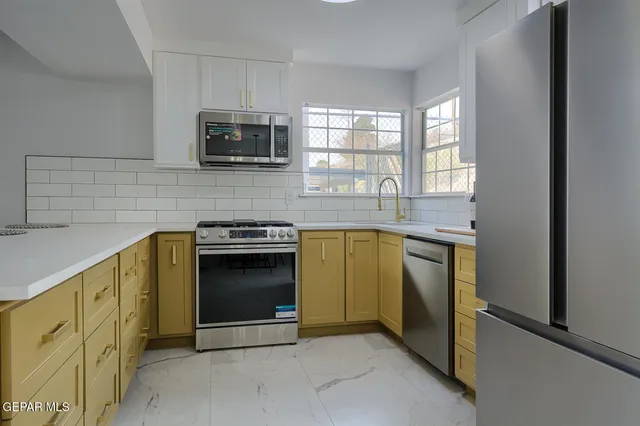 a view of a granite countertop cabinets