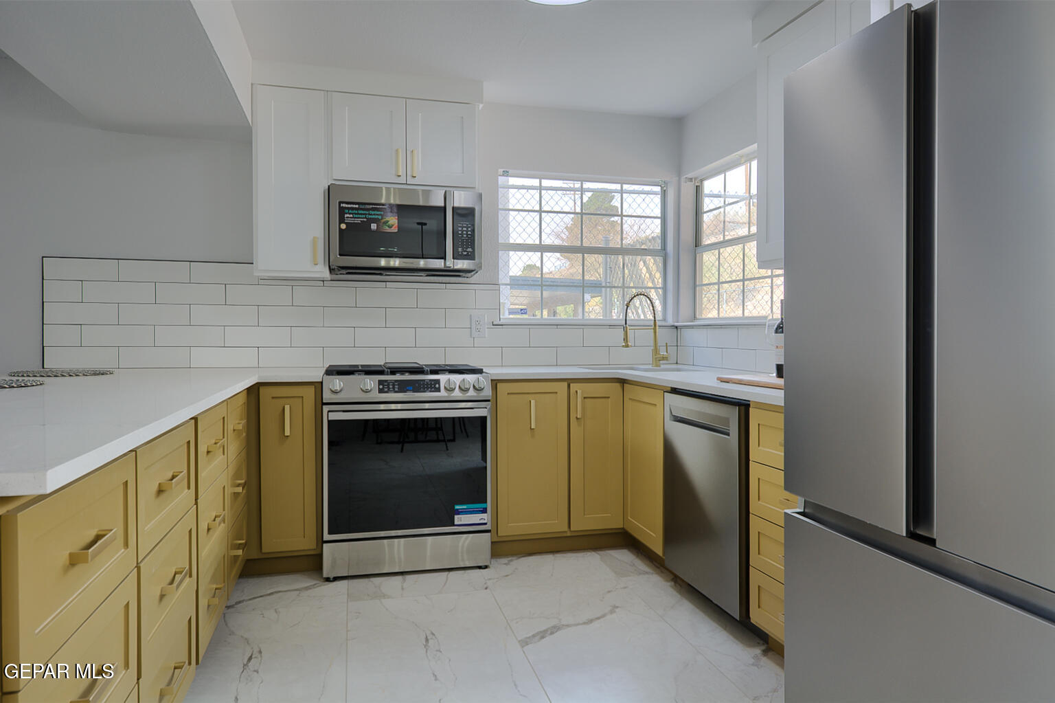 7413 Le Conte Drive El Paso, TX 79912 - Photo 16 of 50 a kitchen with granite countertop a stove and a microwave