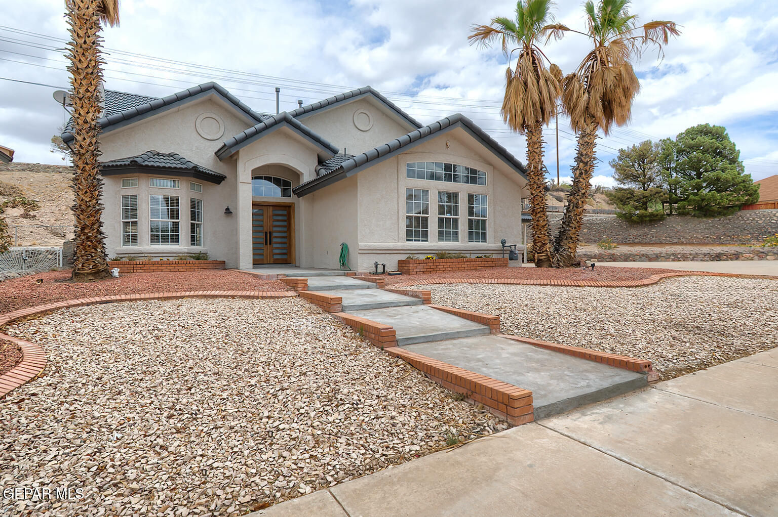 7413 Le Conte Drive El Paso, TX 79912 - Photo 2 of 50 a front view of a house with a yard