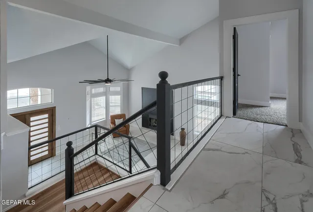 a view of staircase with lots of frames on wall