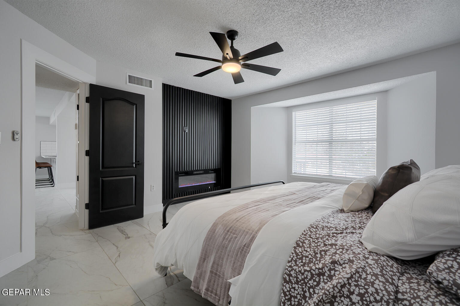 7413 Le Conte Drive El Paso, TX 79912 - Photo 24 of 50 a bedroom with a large bed and a chandelier