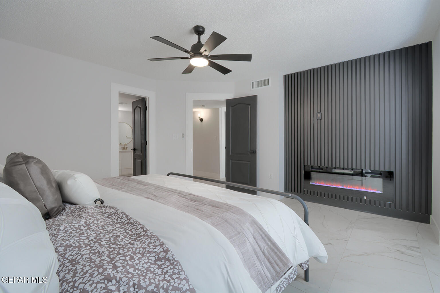 7413 Le Conte Drive El Paso, TX 79912 - Photo 25 of 50 a bedroom with a large bed and a chandelier