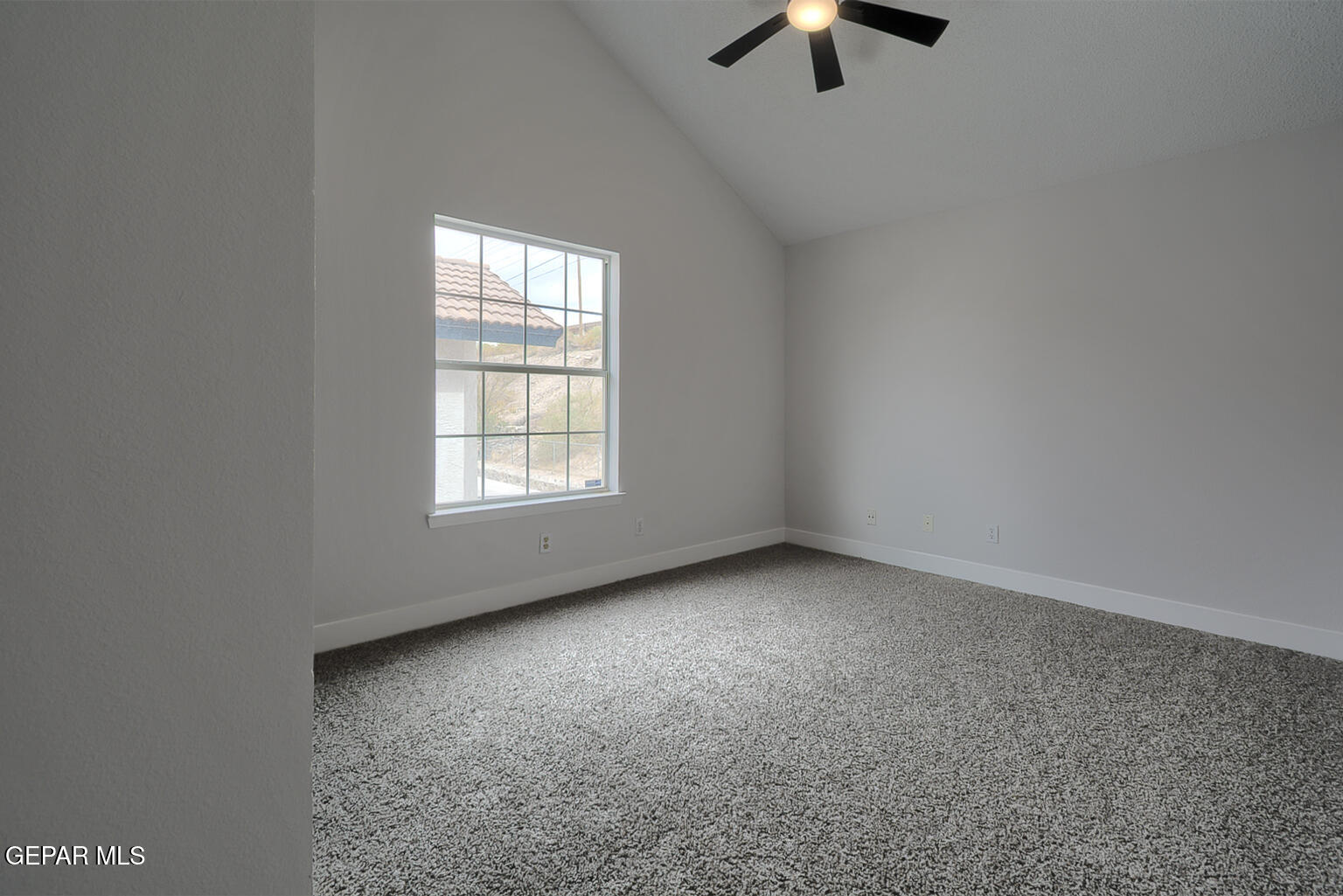7413 Le Conte Drive El Paso, TX 79912 - Photo 37 of 50 an empty room with chandelier fan and windows
