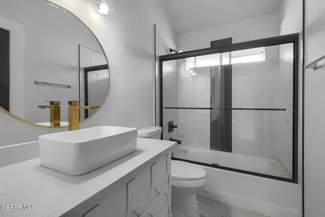 a bathroom with a glass shower door