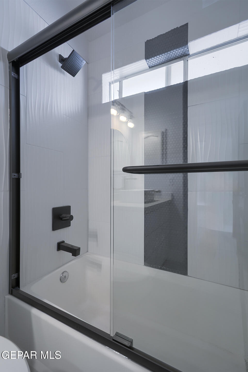 7413 Le Conte Drive El Paso, TX 79912 - Photo 43 of 50 a bathroom with a glass shower door