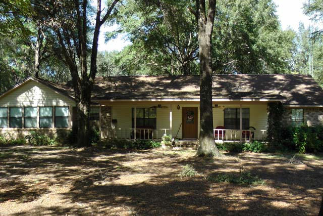 3845 Poverty Creek Road Crestview, FL 32539 - Photo 1 of 32 a front view of a house with a tree