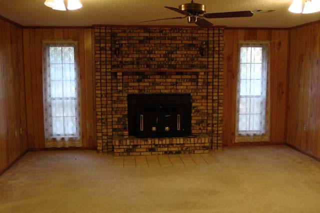 3845 Poverty Creek Road Crestview, FL 32539 - Photo 14 of 32 a living room with fireplace and a window