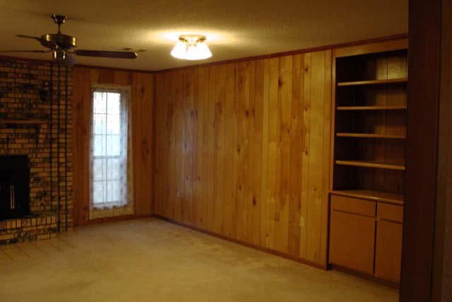 3845 Poverty Creek Road Crestview, FL 32539 - Photo 15 of 32 a view of an empty room with a fireplace and a window
