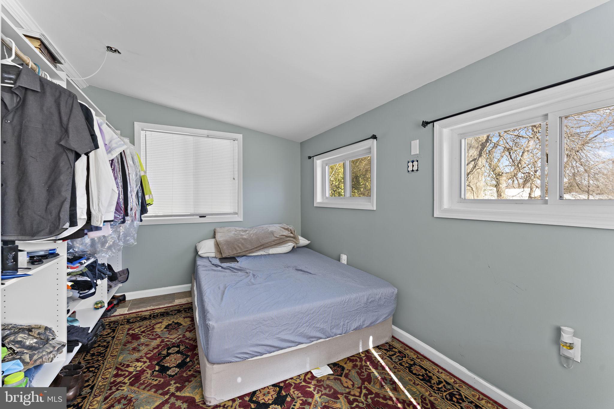 12911 Valleywood Drive Silver Spring, MD 20906 - Photo 18 of 43 a bedroom with a bed and a window