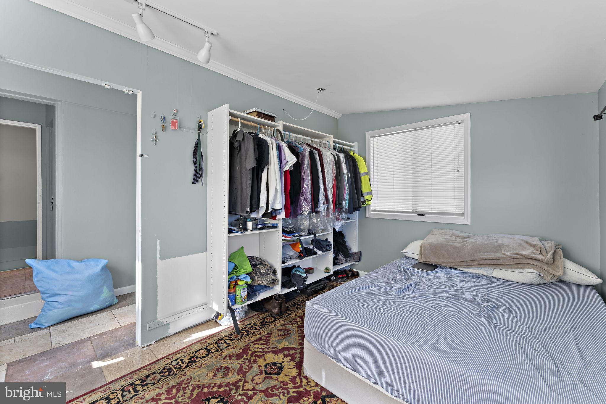 12911 Valleywood Drive Silver Spring, MD 20906 - Photo 19 of 43 a bedroom with a bed and a window