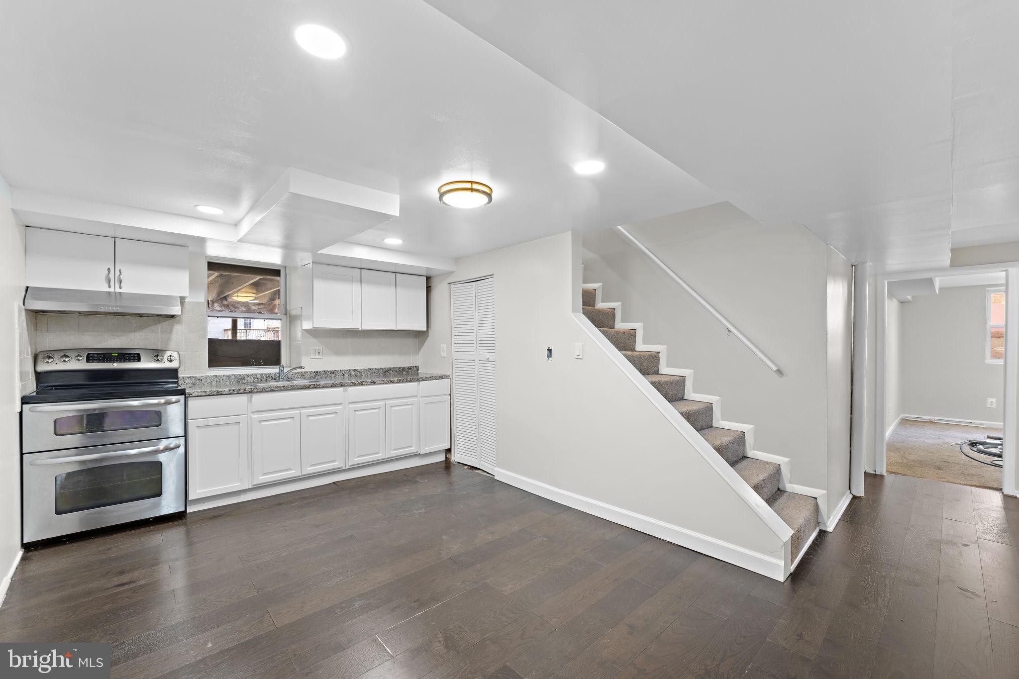 12911 Valleywood Drive Silver Spring, MD 20906 - Photo 20 of 43 a kitchen with a refrigerator and a stove top oven
