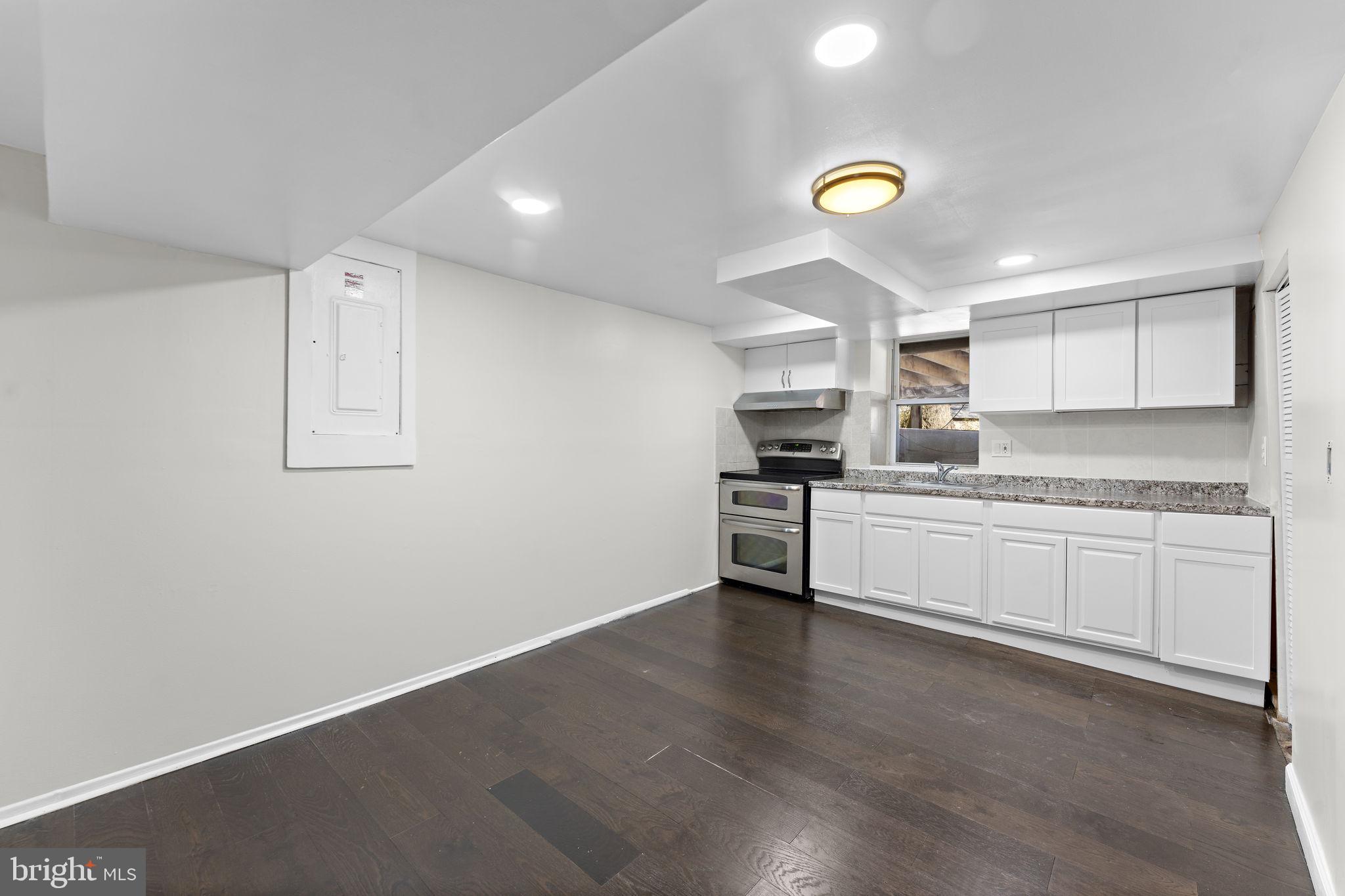12911 Valleywood Drive Silver Spring, MD 20906 - Photo 21 of 43 a kitchen with a refrigerator and white cabinets