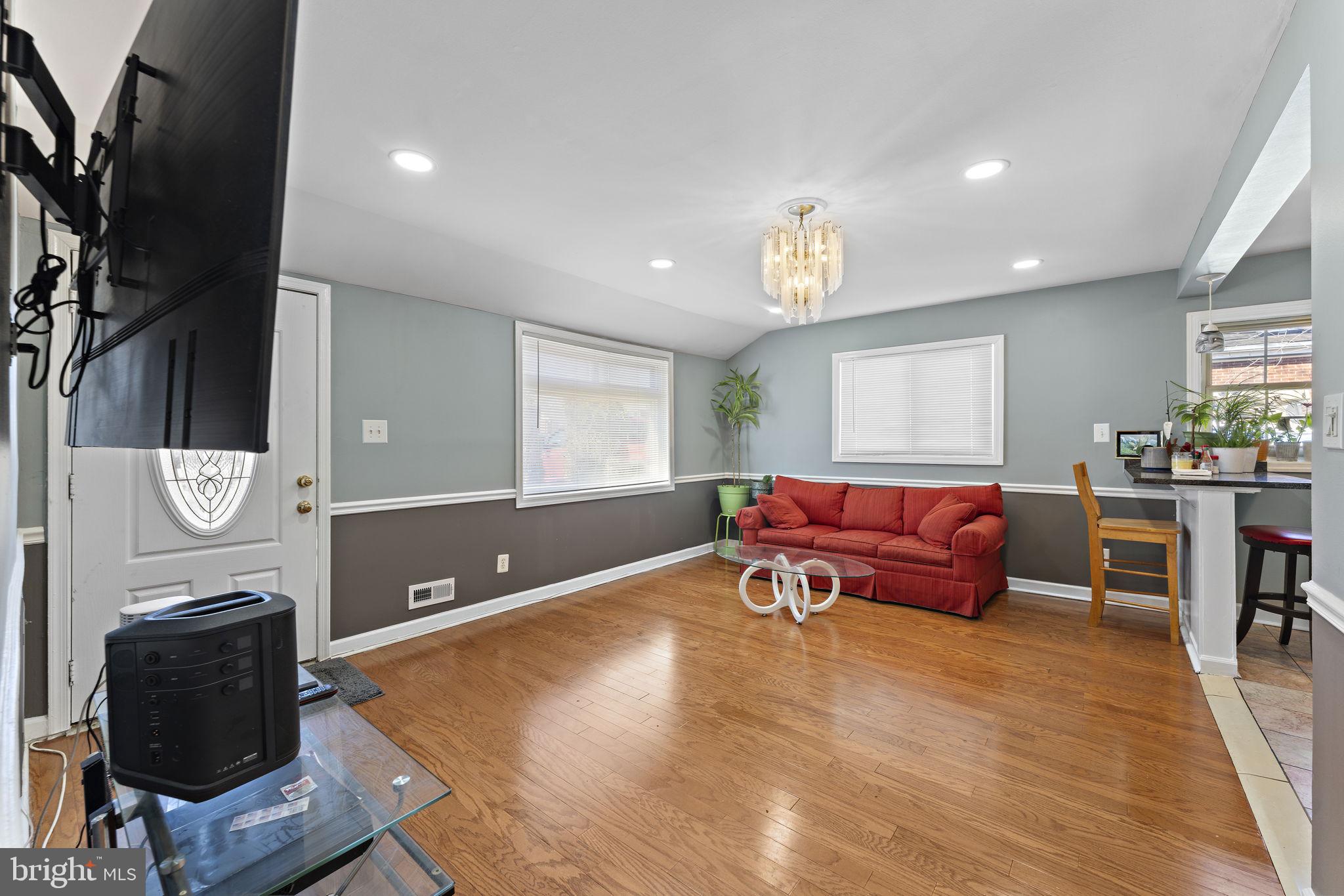 12911 Valleywood Drive Silver Spring, MD 20906 - Photo 3 of 43 a living room with furniture a window and a bookshelf