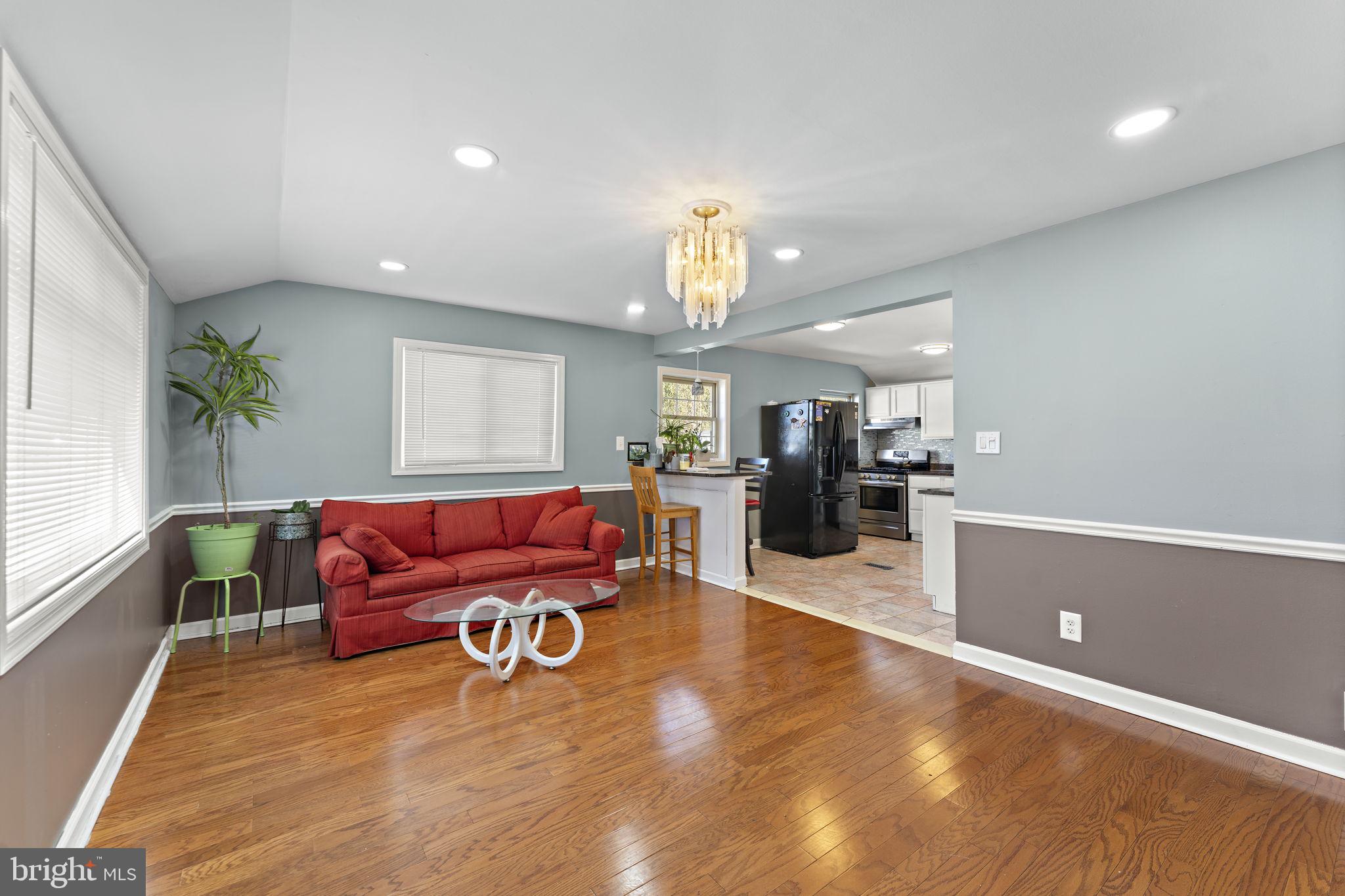 12911 Valleywood Drive Silver Spring, MD 20906 - Photo 4 of 43 a living room with furniture and a wooden floor