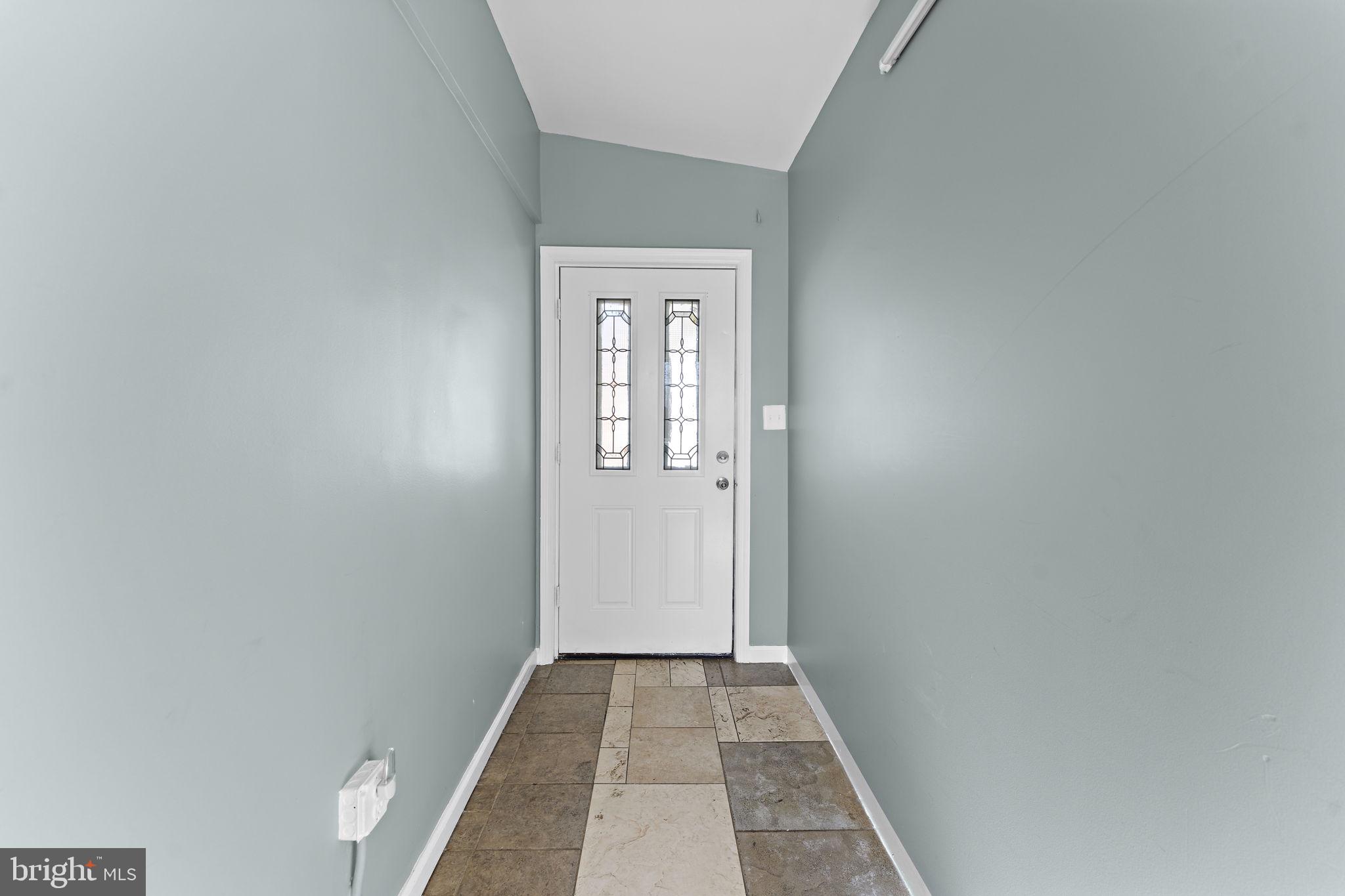 12911 Valleywood Drive Silver Spring, MD 20906 - Photo 6 of 43 a view of a hallway with wooden floor and a window