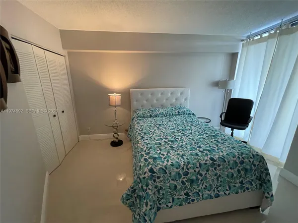 a bathroom with a bathtub shower and a sink