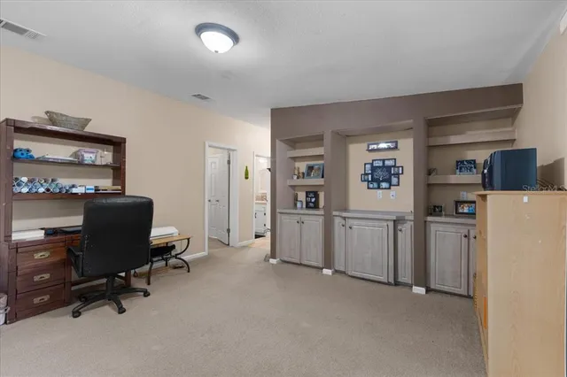 a bedroom with a bed a couch and a chandelier