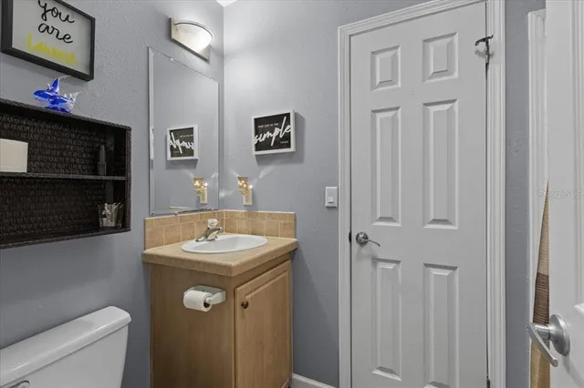 a living room with furniture ceiling fan and a window