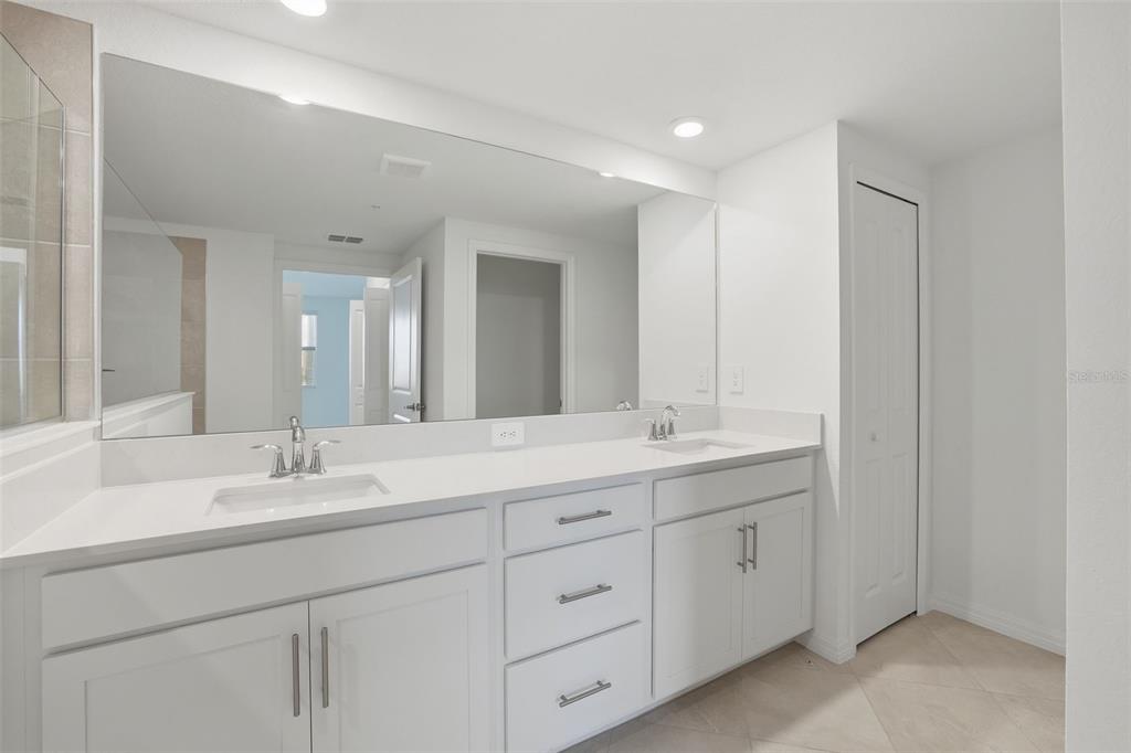 19219 Cherrystone Way, Unit 101 Lakewood Ranch, FL 34211 - Photo 13 of 19 a bathroom with double sink and a mirror