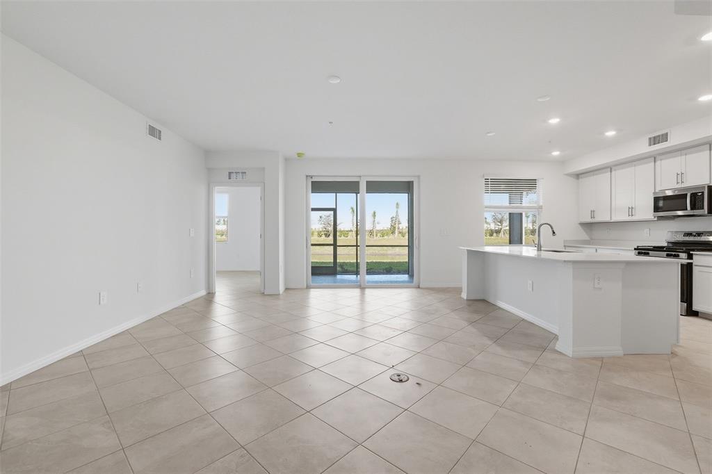 19219 Cherrystone Way, Unit 101 Lakewood Ranch, FL 34211 - Photo 2 of 19 a view of a kitchen with microwave and cabinets