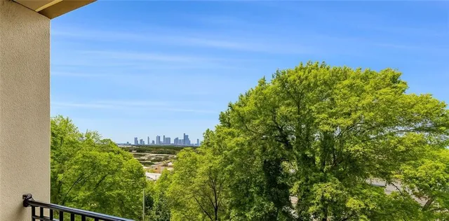 an empty room with windows and fireplace