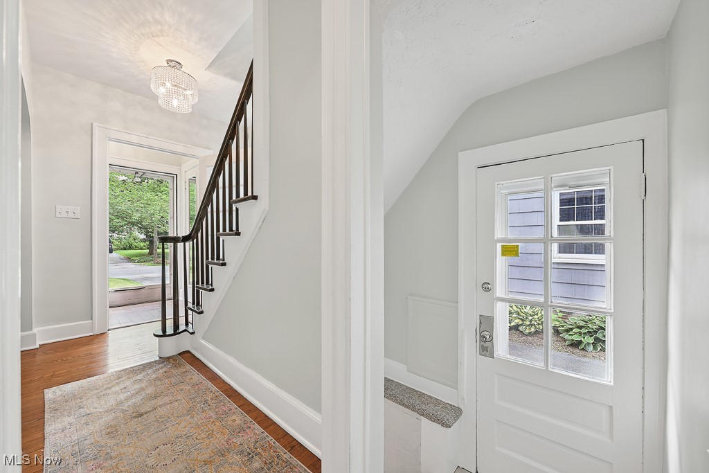 3266 Avalon Road Cleveland, OH 44120 - Photo 31 of 46 Entryway with wood finished floors, stairway, and a chandelier