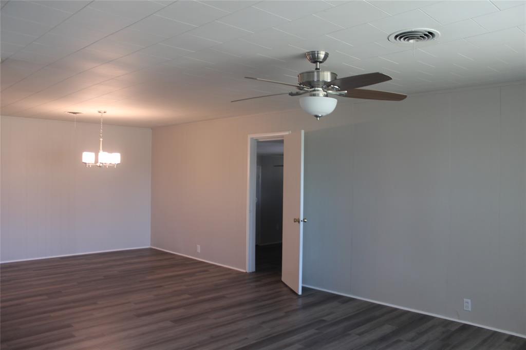 409 West Main Street Azle, TX 76020 - Photo 3 of 12 wooden floor in an empty room with a window