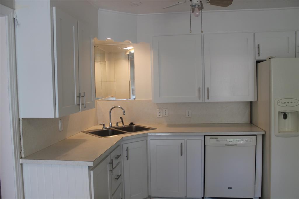 409 West Main Street Azle, TX 76020 - Photo 4 of 12 a kitchen with a sink and cabinets