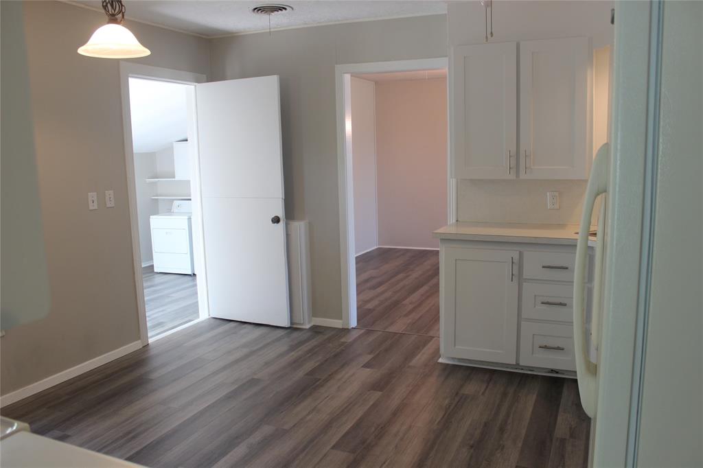409 West Main Street Azle, TX 76020 - Photo 5 of 12 an empty room with wooden floor and closet