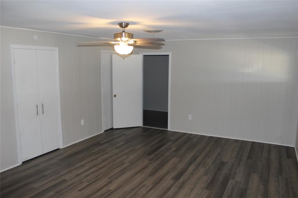 409 West Main Street Azle, TX 76020 - Photo 7 of 12 wooden floor in an empty room with a mirror