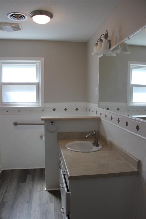 409 West Main Street Azle, TX 76020 - Photo 9 of 12 a bathroom with a sink and a mirror