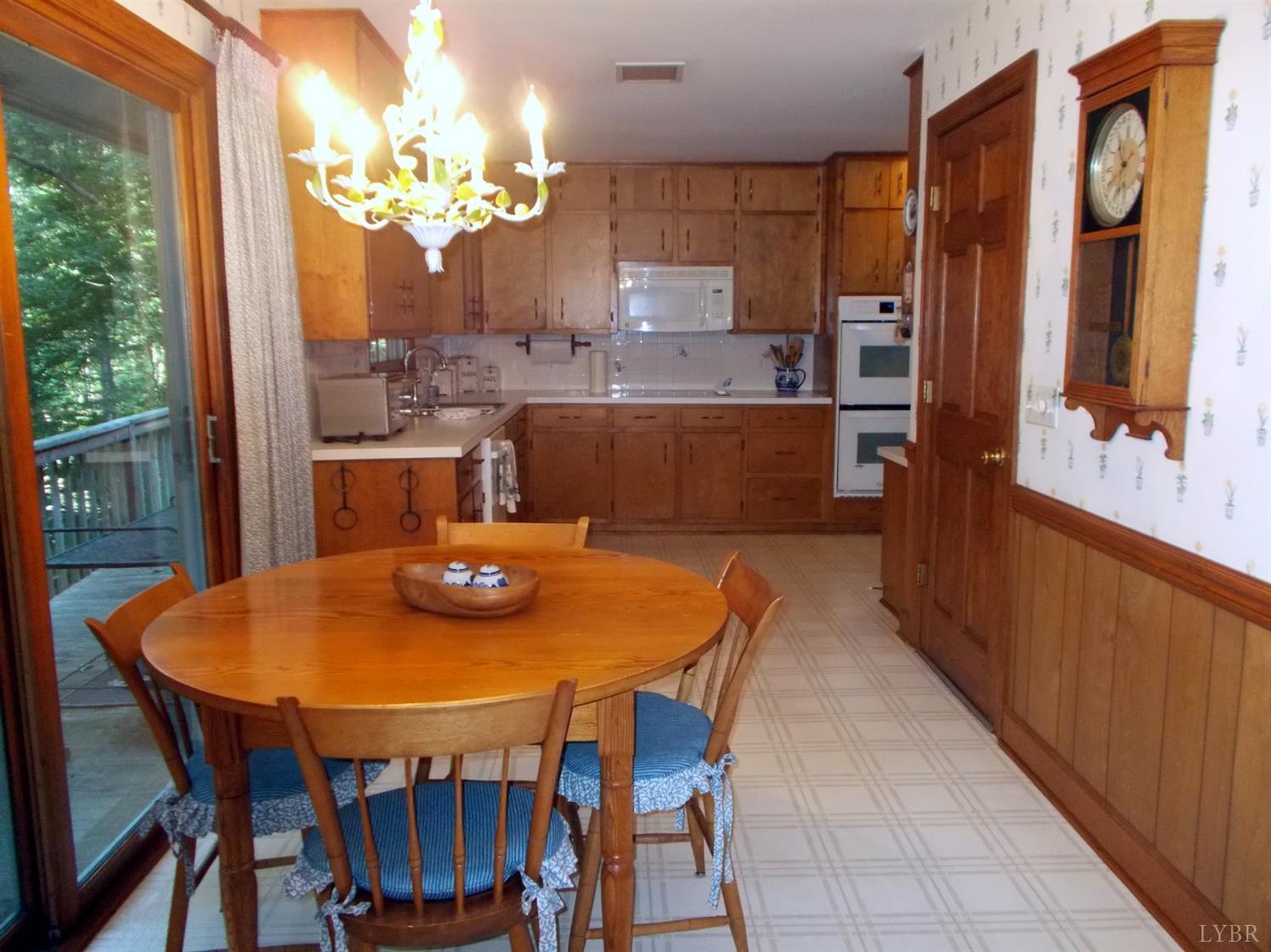 110 River Road Altavista, VA 24517 - Photo 17 of 51 a view of a dining room with furniture a chandelier and wooden floor