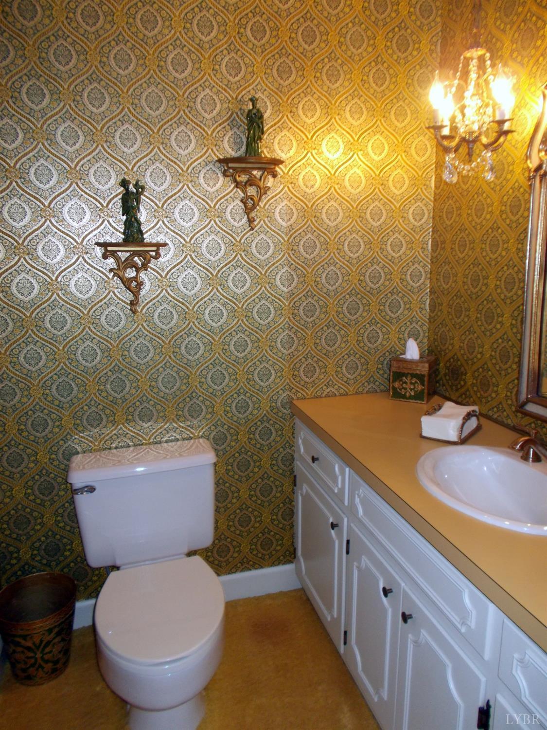 110 River Road Altavista, VA 24517 - Photo 46 of 51 a bathroom with a granite countertop toilet sink and mirror