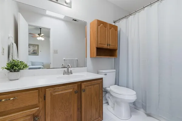 a bathroom with a sink a toilet and mirror