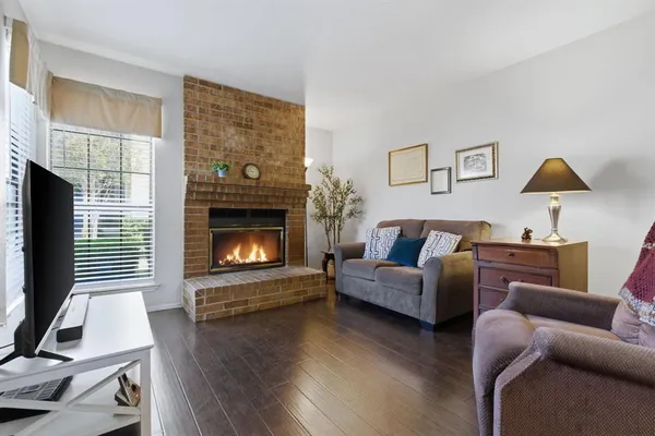 a living room with furniture a fireplace and a flat screen tv