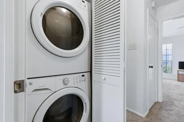 a close view of a utility room with dryer and washer