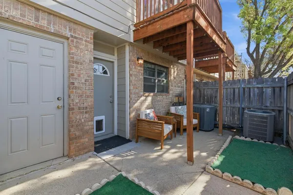 a view of a hallway with wooden floor and a living room