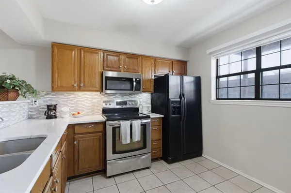 a kitchen with stainless steel appliances granite countertop a refrigerator and a sink