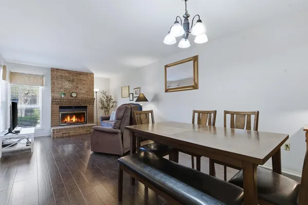 a living room with furniture a fireplace and a chandelier