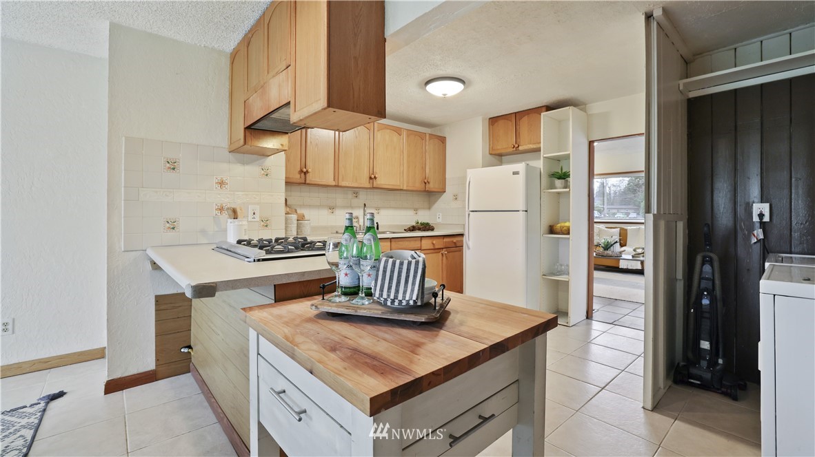 2519 Northeast 9th Street Renton, WA 98056 - Photo 12 of 26 a kitchen with a sink a stove and refrigerator