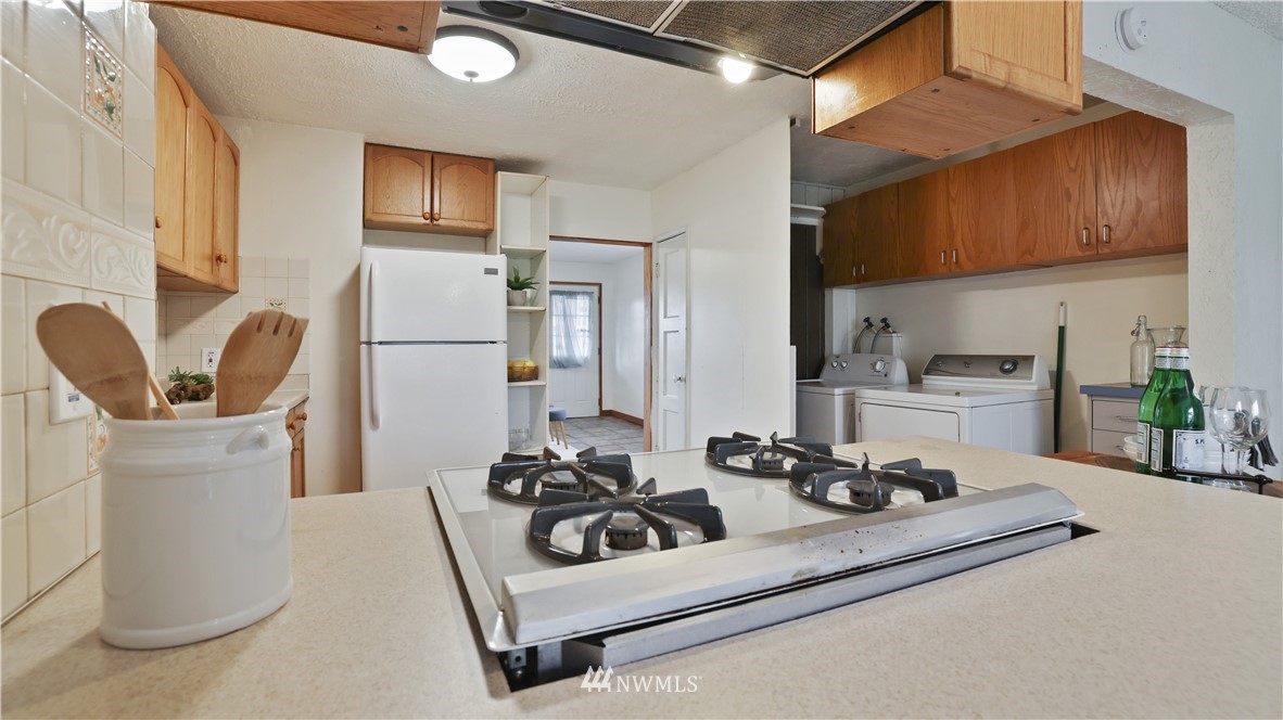 2519 Northeast 9th Street Renton, WA 98056 - Photo 13 of 26 a white kitchen with a sink stove and refrigerator