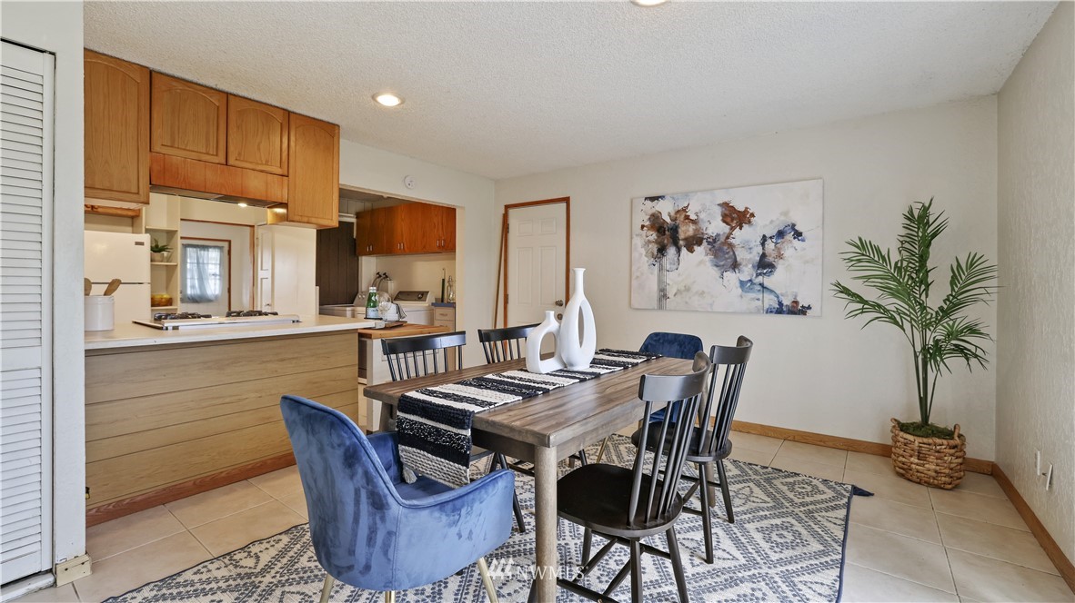 2519 Northeast 9th Street Renton, WA 98056 - Photo 15 of 26 a view of a dining room with furniture window and wooden floor