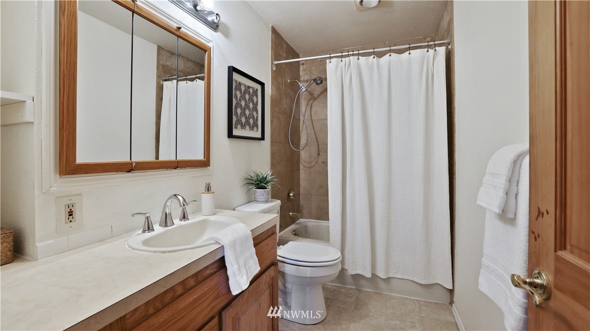 2519 Northeast 9th Street Renton, WA 98056 - Photo 8 of 26 a bathroom with a sink a toilet and shower