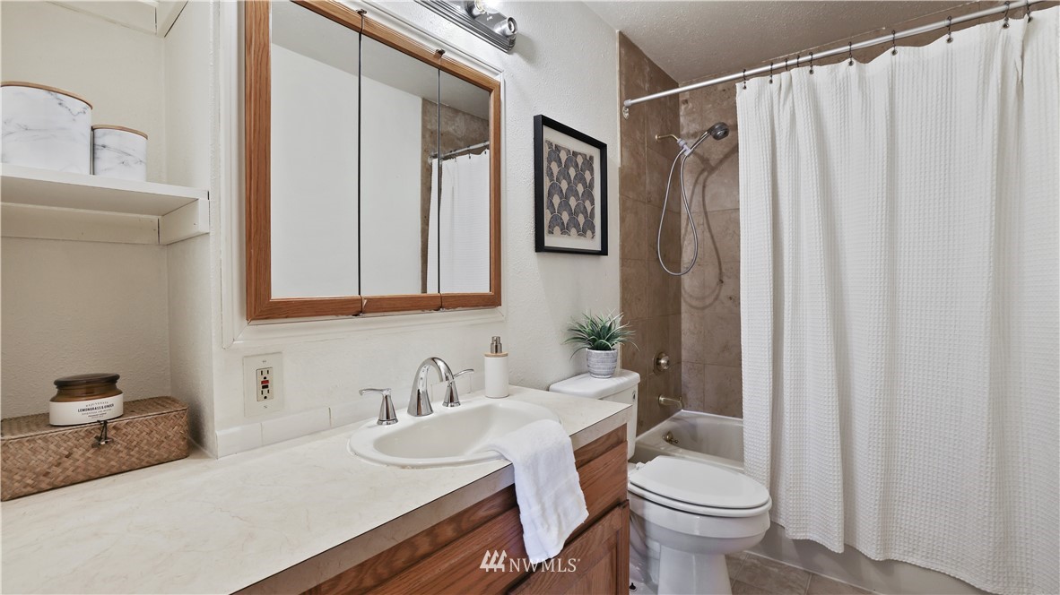 2519 Northeast 9th Street Renton, WA 98056 - Photo 9 of 26 a bathroom with a sink toilet and shower