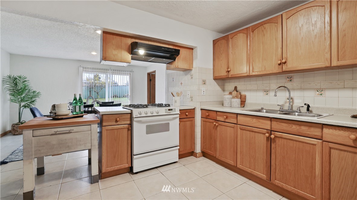 2519 Northeast 9th Street Renton, WA 98056 - Photo 10 of 26 a kitchen with white cabinets and white appliances